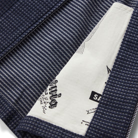 material shot of the interior map print detail on  The Cavern Jacket in Navy Dobby Grid