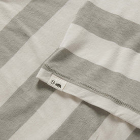 material shot of the TS label on The Cotton Hemp Tee in Natural and Sagebrush Stripe