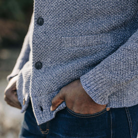 fit model with his hands in his pockets wearing The Crawford Sweater in Blue Melange
