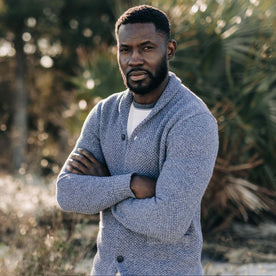 fit model with his arms crossed wearing The Crawford Sweater in Blue Melange