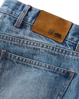 material shot of the logo patch on The Democratic Jean in Fletcher Wash Organic Selvage, Bottoms by Taylor Stitch