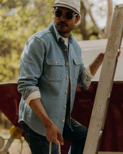 fit model sitting wearing The Division Shirt in Washed Indigo