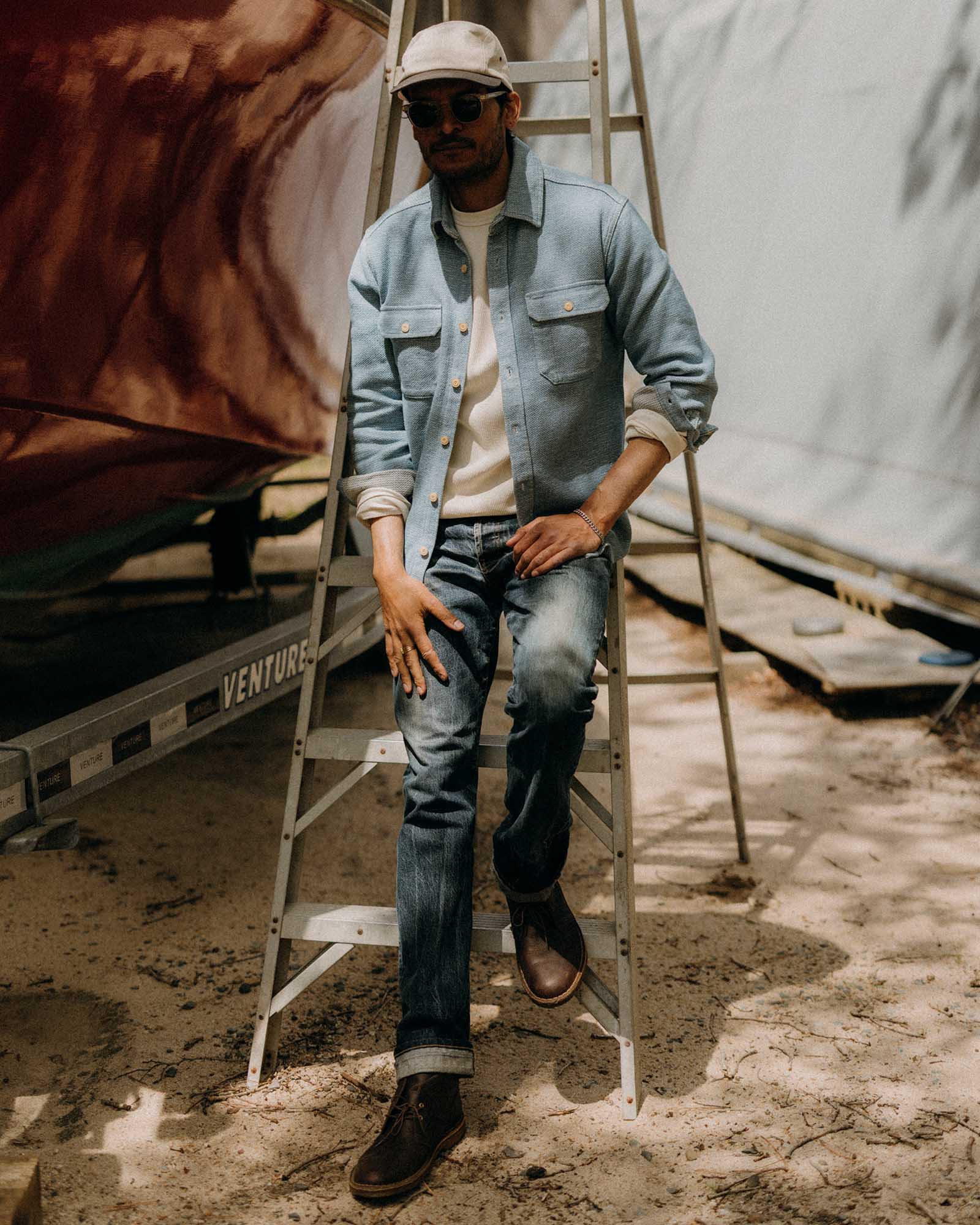 fit model adjusting sleeve on The Division Shirt in Washed Indigo, Wovens by Taylor Stitch