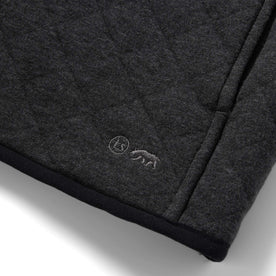 material shot of the TS logo on The Fall Line Pullover in Coal Heather