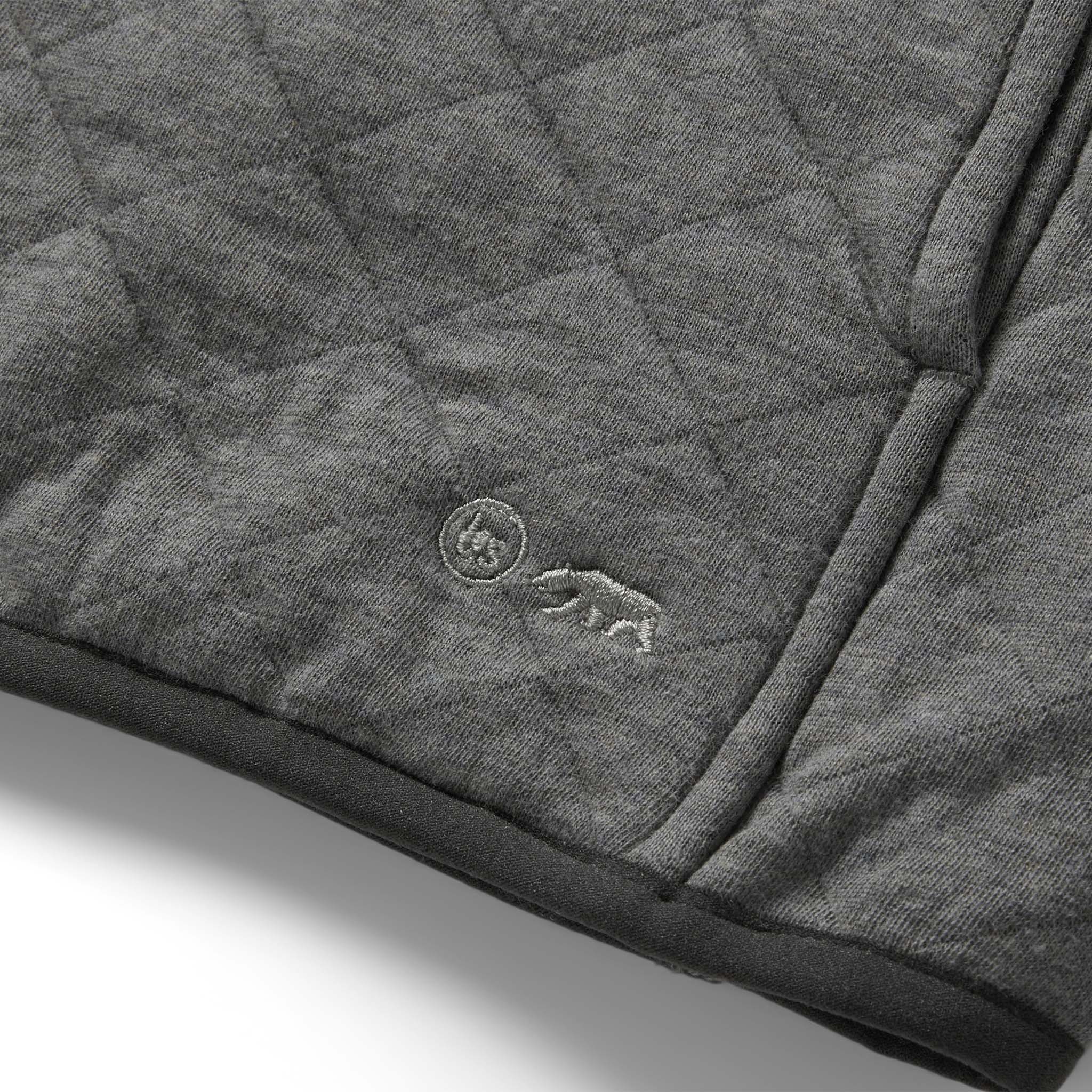 material shot of the TS logo on The Fall Line Pullover in Cypress Heather, Knits by Taylor Stitch