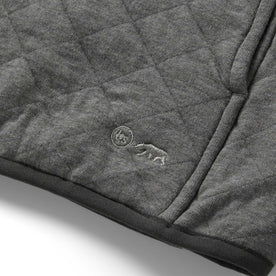 material shot of the TS logo on The Fall Line Pullover in Cypress Heather