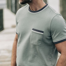 fit model showing the front of The Heavy Bag Ringer Tee in Slate and Seed