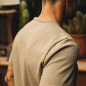 fit model showing the back of The Heavy Bag Tee in Arid Eucalyptus