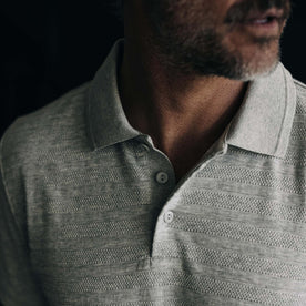 fit model showing the front of The Jacquard Polo in Ash Heather