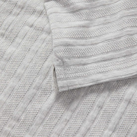 material shot of the hem on The Jacquard Polo in Ash Heather