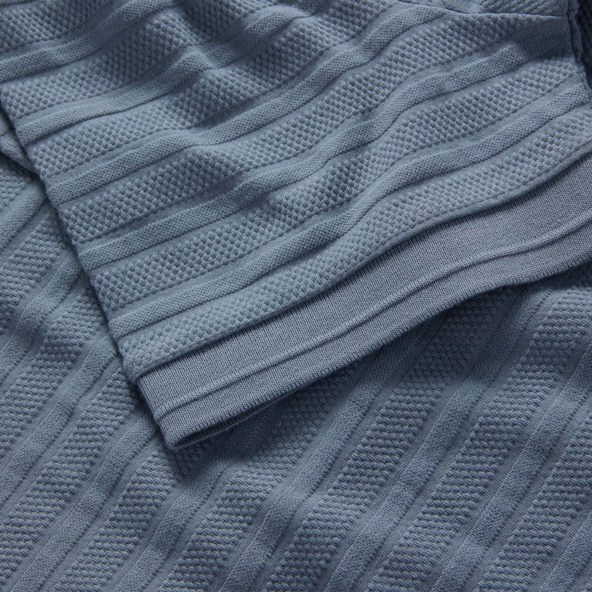 material shot of the sleeve on The Jacquard Polo in Storm, Knits by Taylor Stitch