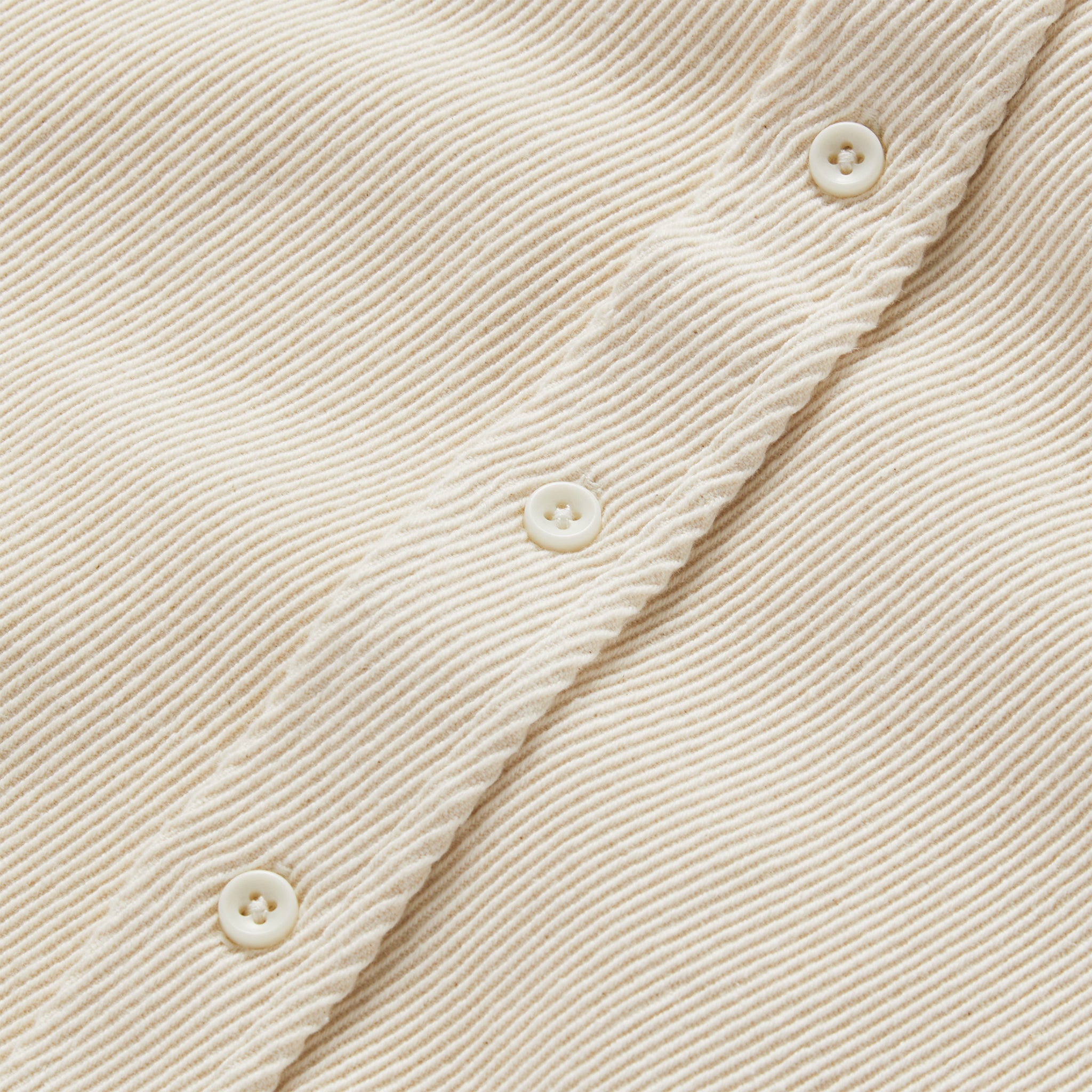 material shot of the buttons and texture of The Ledge Shirt in Natural Twill, Wovens by Taylor Stitch