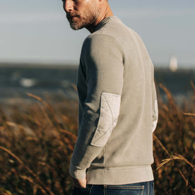 fit model showing off the back of The Moor Sweater in Slate