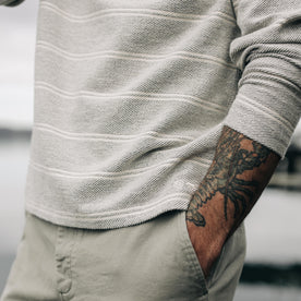fit model with his hands in his pockets wearing The Morgan Crewneck in Ash Stripe