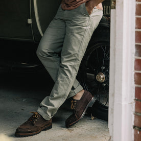 fit model leaning against a car in The Morse Pant in Sagebrush Slub