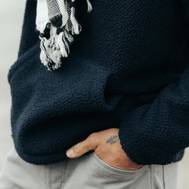 fit model showing the kangaroo pocket on The Nomad Hoodie in Navy Sherpa