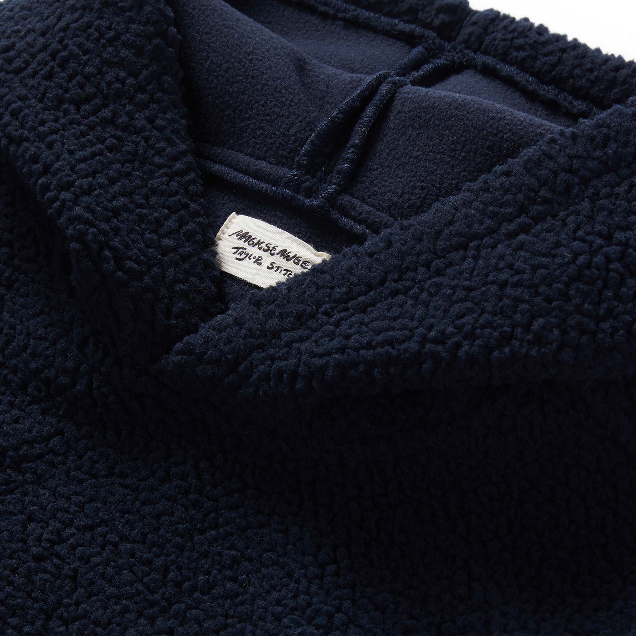 material shot of the fleece and label on The Nomad Hoodie in Navy Sherpa, Outerwear by Taylor Stitch