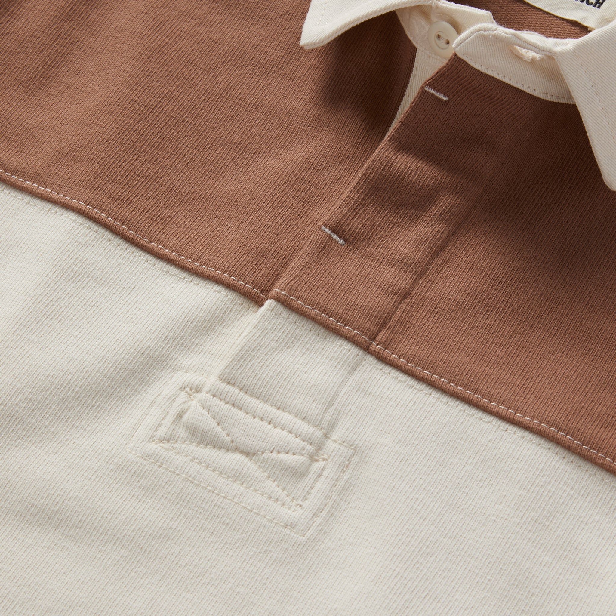 material shot of the buttons on The Rugby Shirt in Mahogany and Natural Color Block, Knits by Taylor Stitch