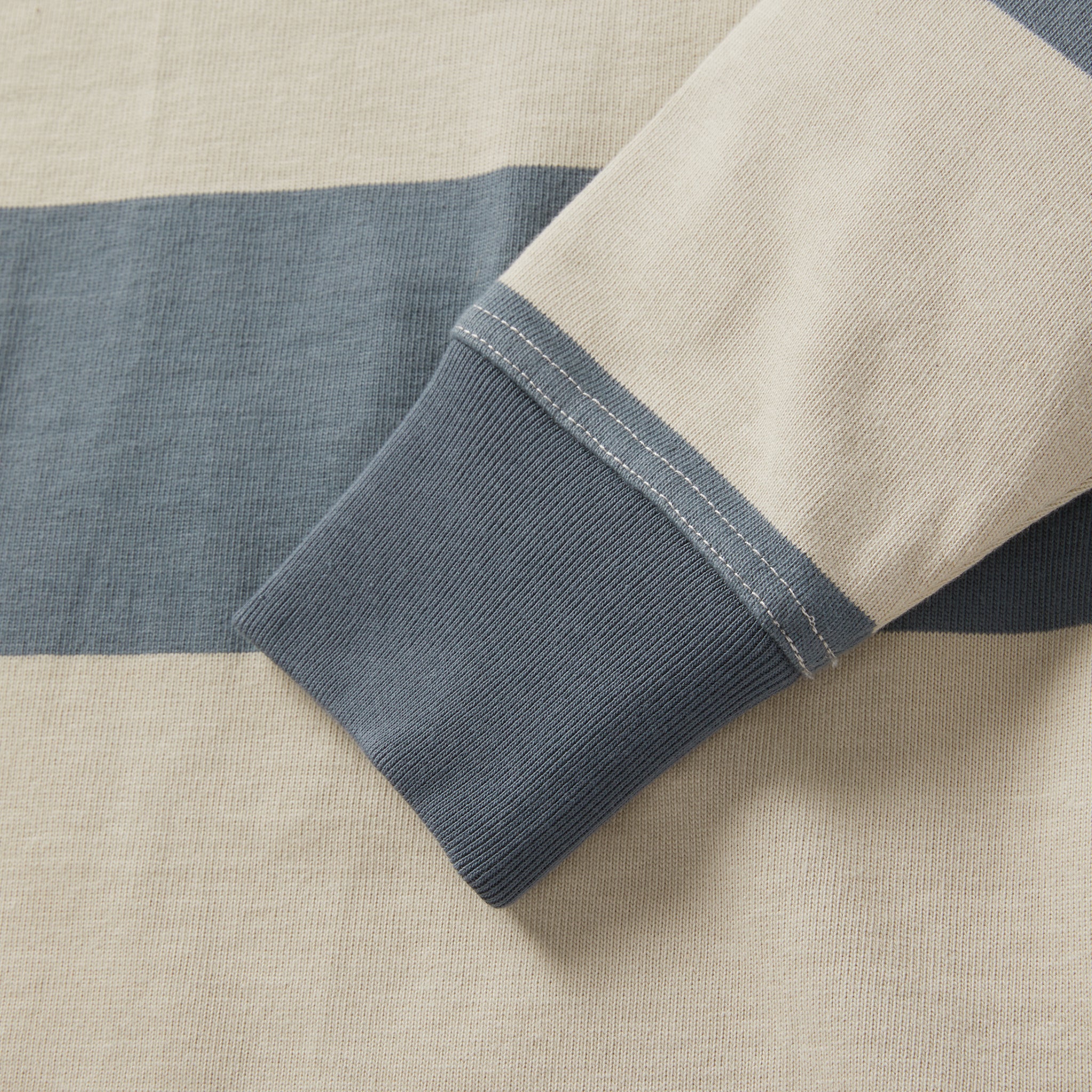 material shot of the sleeve on The Rugby Shirt in Storm Stripe, Knits by Taylor Stitch
