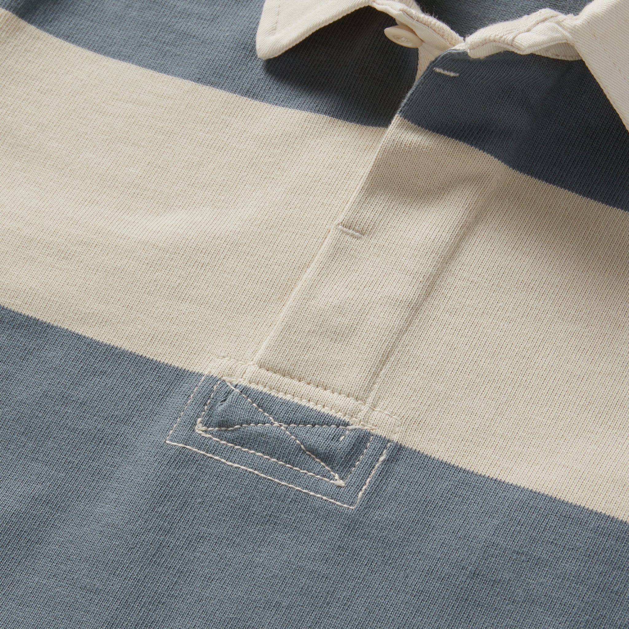 material shot of the buttons on The Rugby Shirt in Storm Stripe, Knits by Taylor Stitch