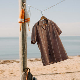 editorial image of The Short Sleeve Hawthorne in Dried Fig Stripe the beach