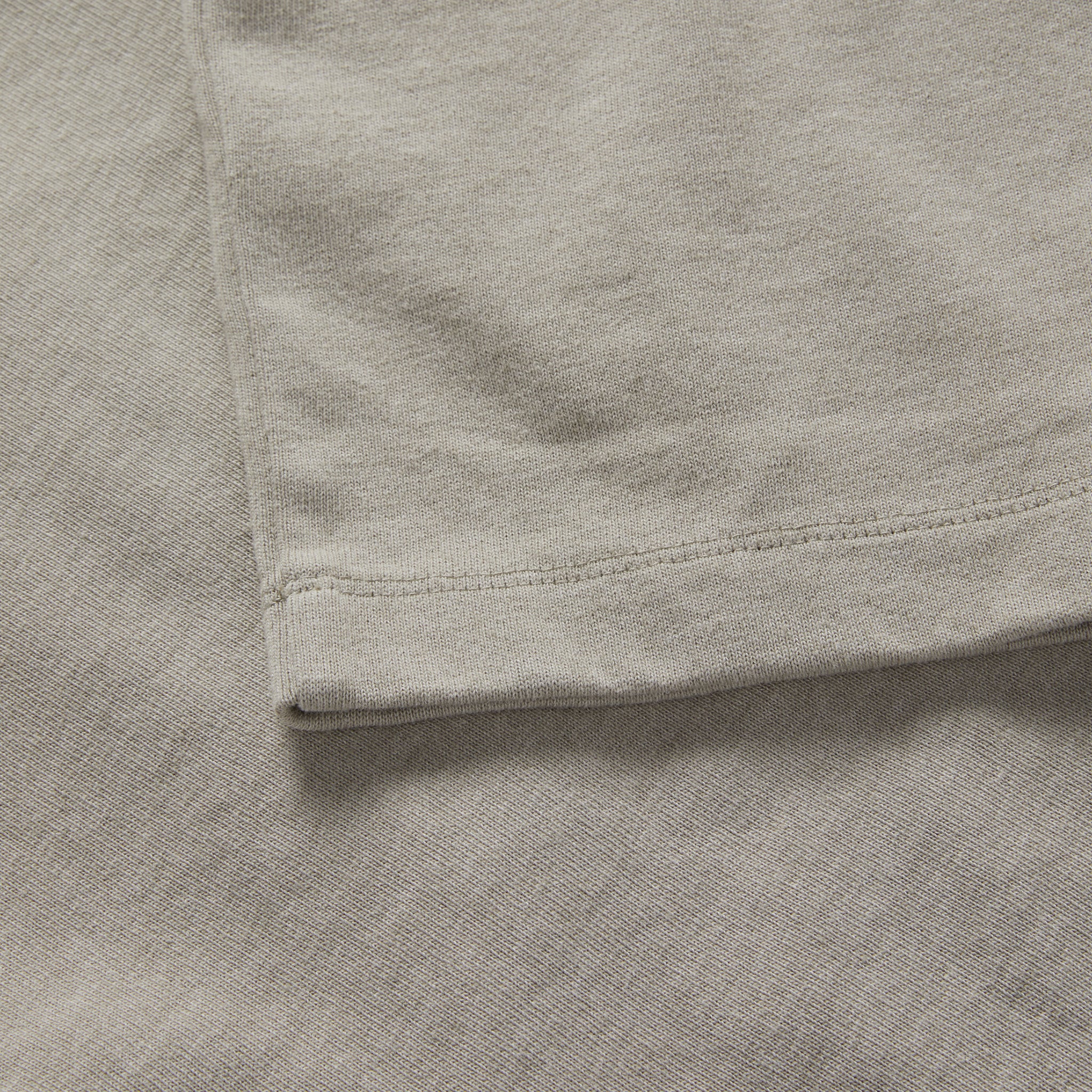material shot of the sleeve on The Short Sleeve Heavy Bag Henley in Fog, Knits by Taylor Stitch
