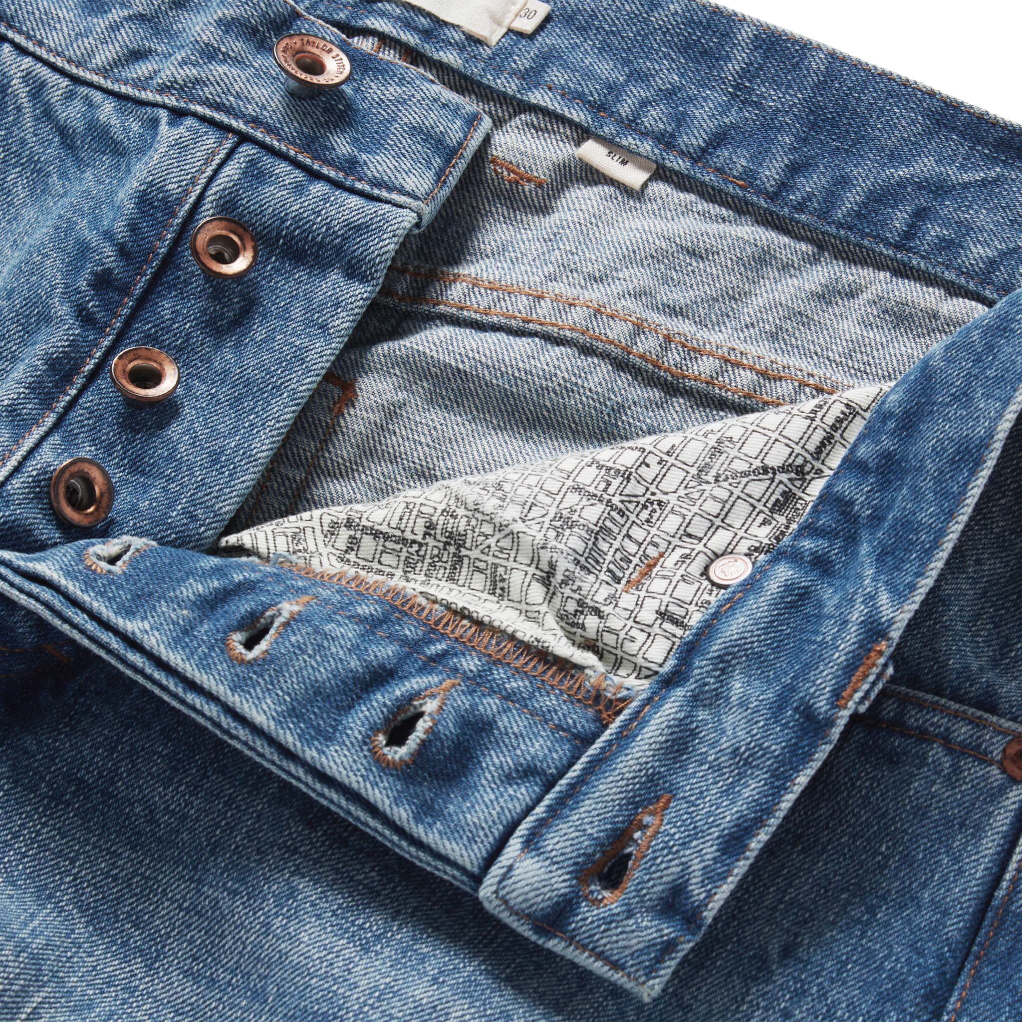 material shot of the button fly on The Slim Jean in Fletcher Wash Organic Selvage, Bottoms by Taylor Stitch