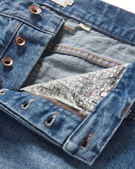 material shot of the button fly on The Slim Jean in Fletcher Wash Organic Selvage, Bottoms by Taylor Stitch