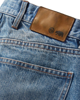 material shot of the logo patch on The Slim Jean in Fletcher Wash Organic Selvage, Bottoms by Taylor Stitch