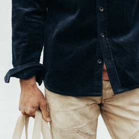 fit model showing the buttons on The Utility Shirt in Dark Navy Crepe Cord