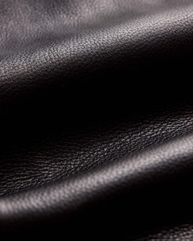 material shot of the zipper and pocket for The Moto Jacket in Black Steerhide, Outerwear by Taylor Stitch