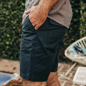 fit model wearing The Adventure Short in Navy from Taylor Stitch, hand in pocket