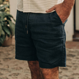 fit model wearing The Apres Short in Navy Hemp, cropped, hand in pocket
