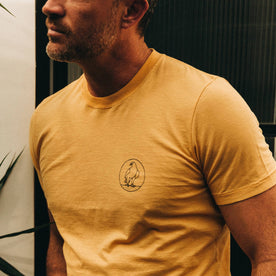 fit model wearing The Cotton Hemp Tee in Canary Eagle, cropped shot of chest