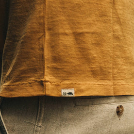 fit model wearing The Cotton Hemp Tee in Canary Eagle, side detail up close