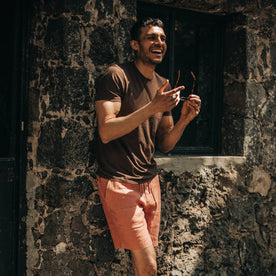 fit model wearing The Cotton Hemp Tee in Espresso Todo Chido, smiling, holding sunglasses