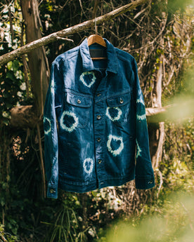 outdoor material shot of The Long Haul Jacket in Hand-Dyed Indigo, hanging on branch, Outerwear by Taylor Stitch