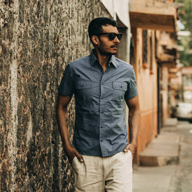 fit model wearing The Short Sleeve Officer Shirt in Slate, hands in pockets