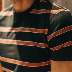fit model wearing The Organic Cotton Tee in Coal and Rust Stripe, sleeve detail