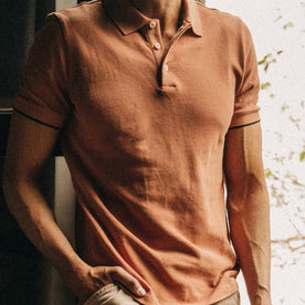 fit model wearing The Pique Polo in Coral, chest detail