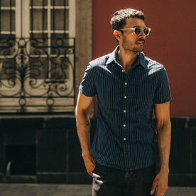 fit model wearing The Short Sleeve California in Indigo Jacquard Stripe, looking right of camera