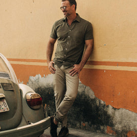 fit model wearing The Short Sleeve California in Olive Pique, looking left