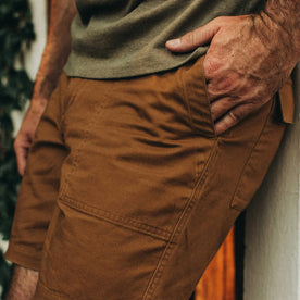 fit model wearing The Trail Short in Tobacco, hand in pocket