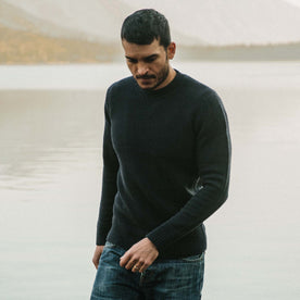 fit model wearing The Ventana Sweater in Navy in front of a lake