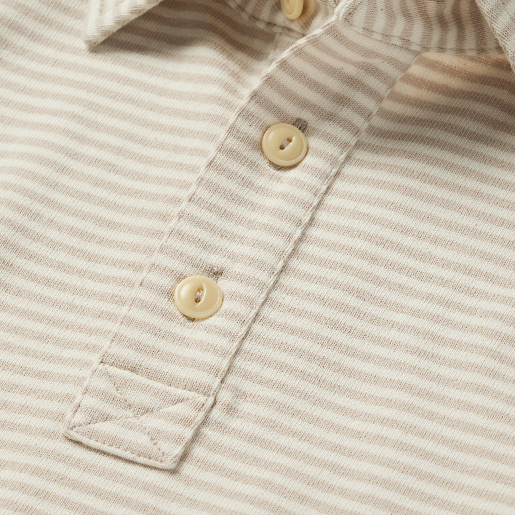 material shot of the buttons on The Heavy Bag Polo in Natural and Oatmeal Stripe, Knits by Taylor Stitch