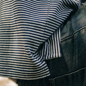 fit model showing the side of The Heavy Bag Polo in Navy and Ash Stripe