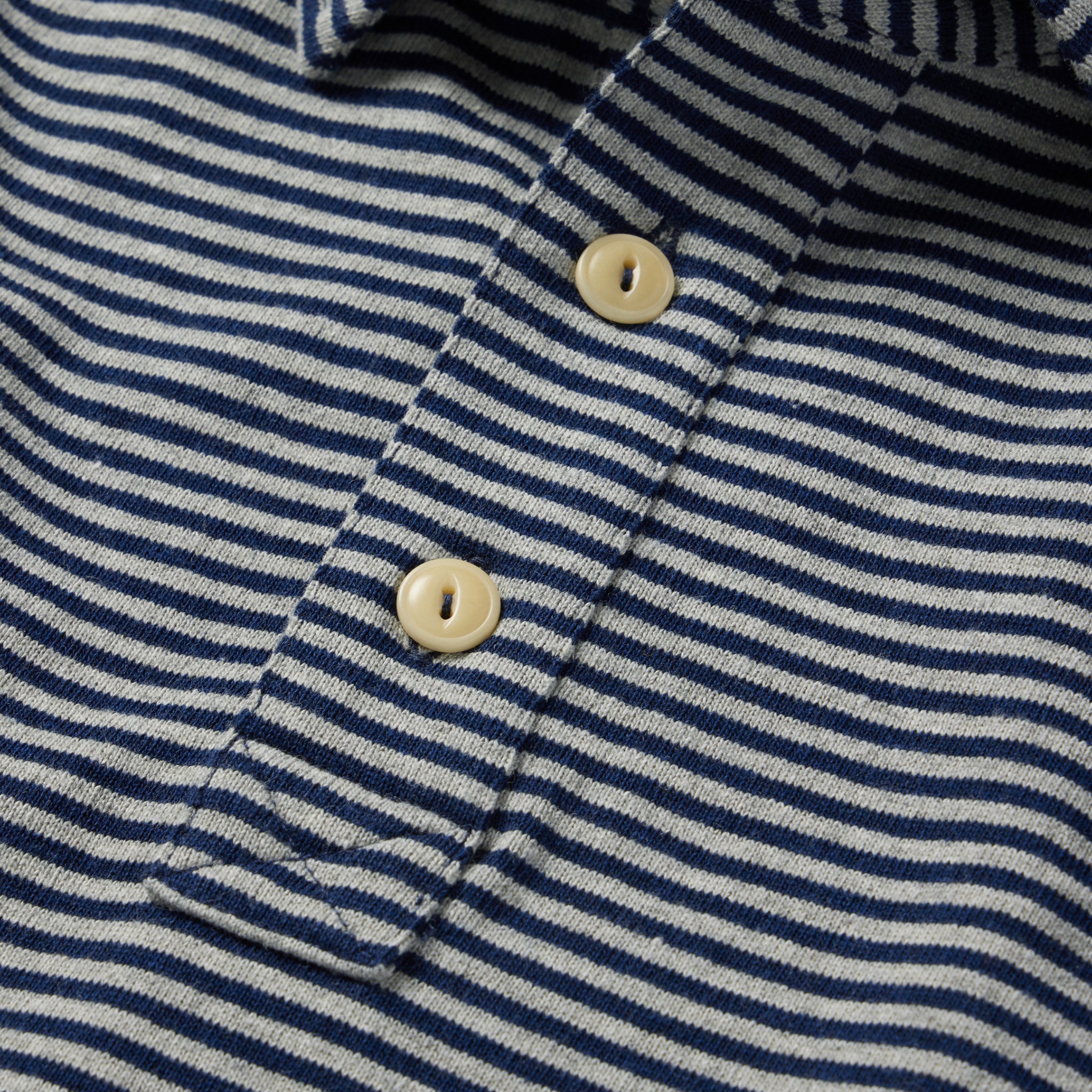 material shot of the buttons on The Heavy Bag Polo in Navy and Ash Stripe, Knits by Taylor Stitch