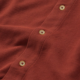 material shot of the buttons on The Short Sleeve California in Red Clay Pique