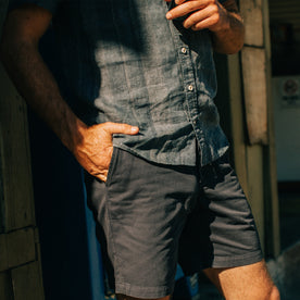 fit model with his hand in his pocket wearing The Short Sleeve California in Dusk Stripe