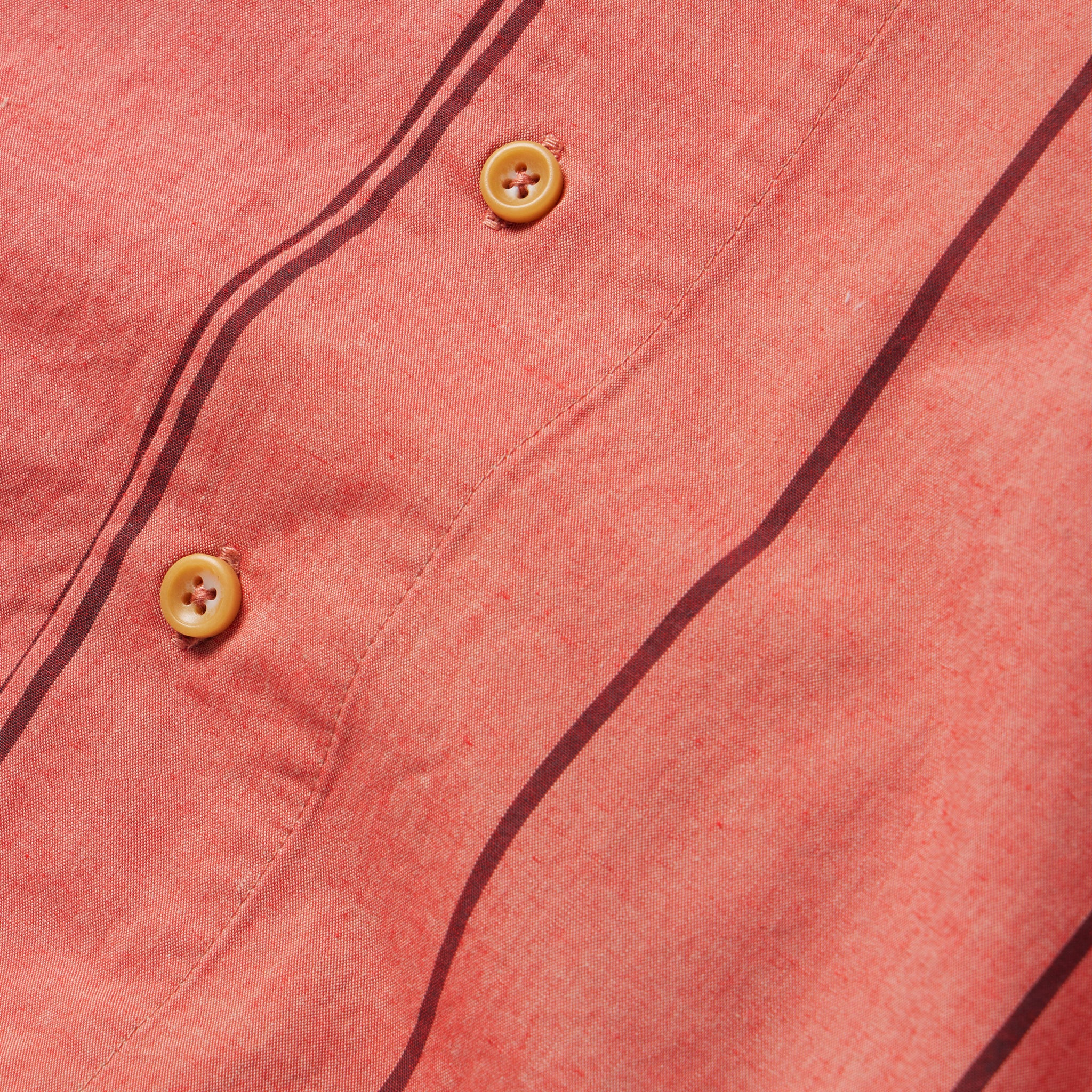 material shot of the buttons on The Short Sleeve Hawthorne in Rust Stripe , Wovens by Taylor Stitch